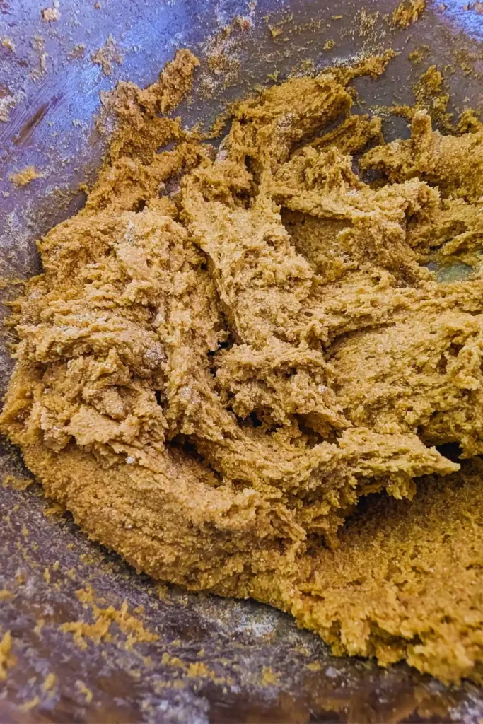 the mixed oat flour cookie dough in a stainless steel mixing bowl