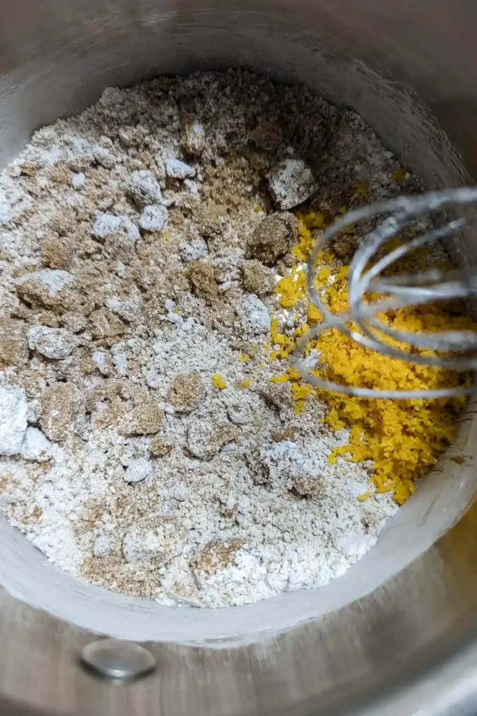 adding orange zest to brown sugar and cornstarch in saucepan