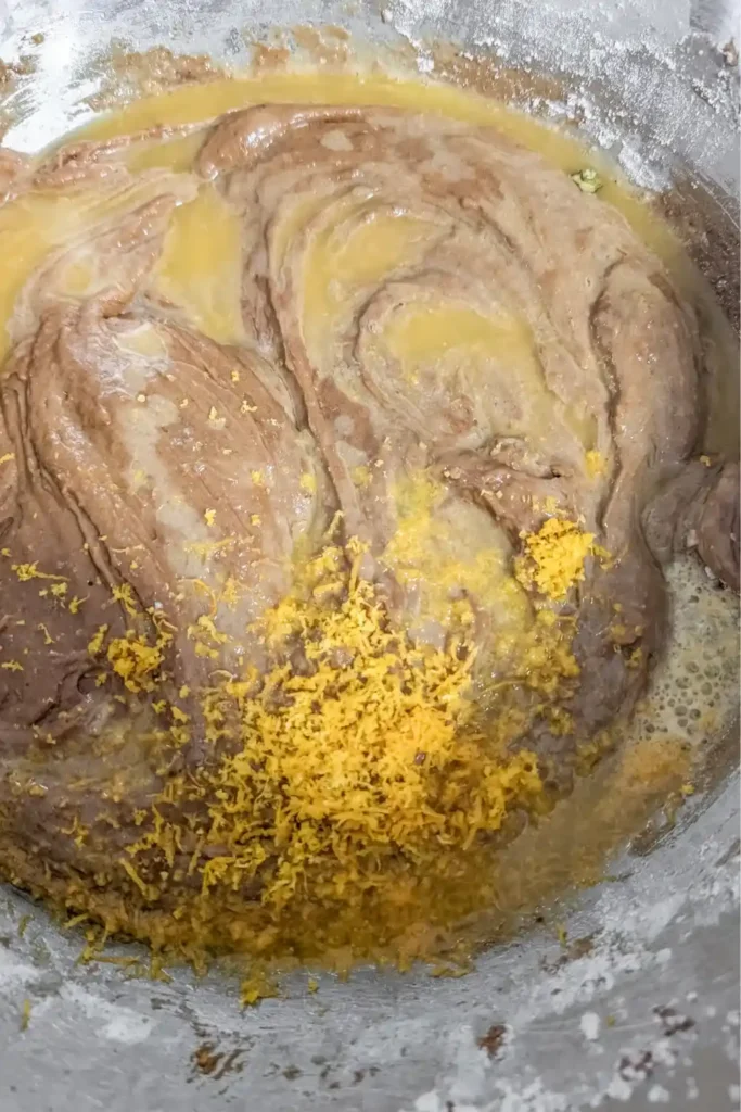 adding orange juice and zest to the gingerbread batter