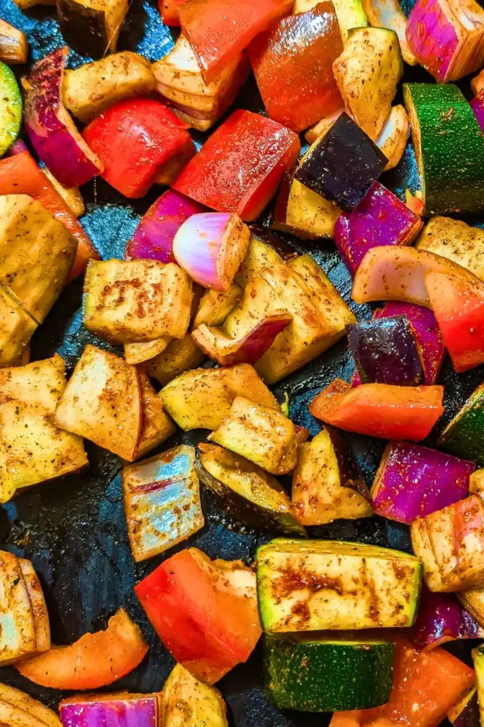single layer of spiced vegetables on baking sheet