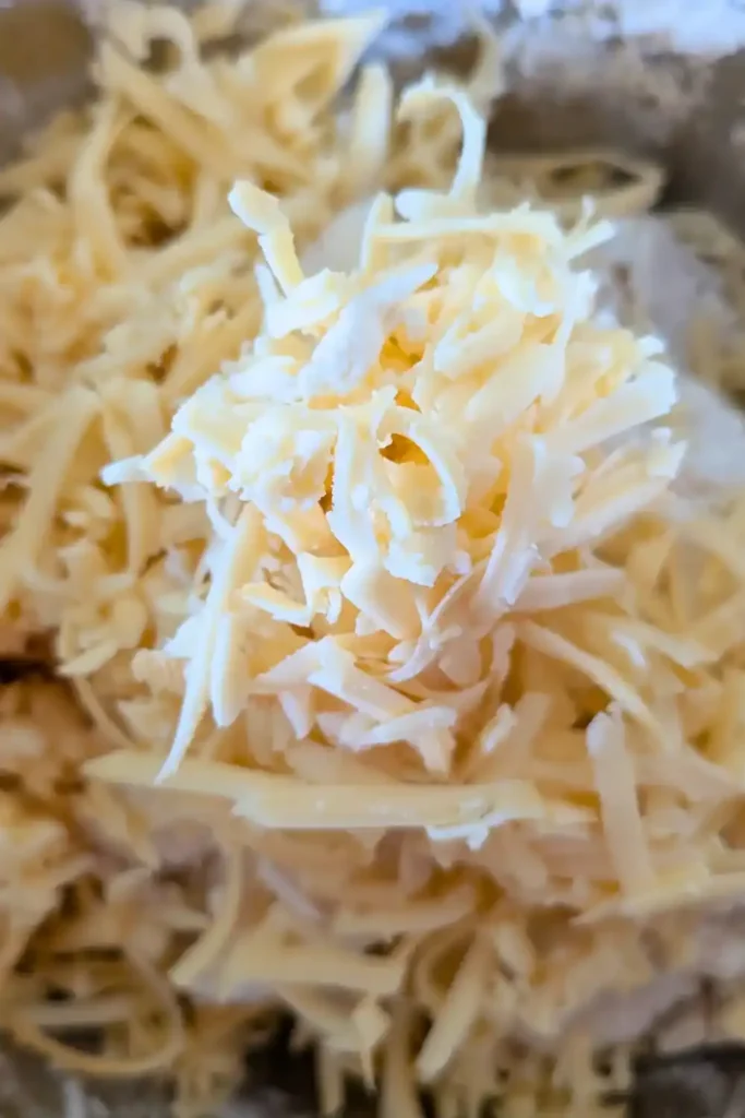 adding the smoked gouda to the baking powder biscuit dough