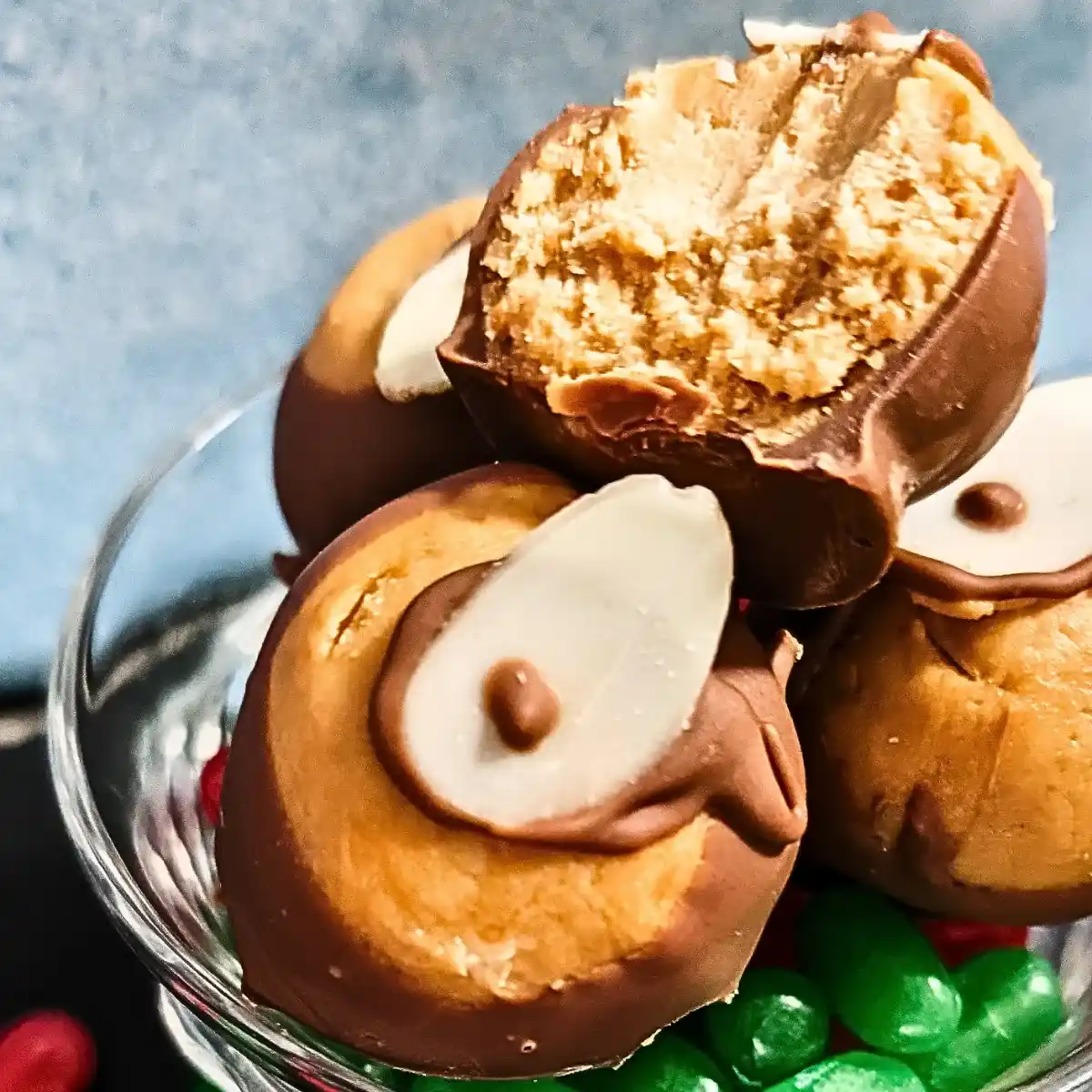 closeup of buckeyes in candy dish with jelly beans one sits on top half eaten