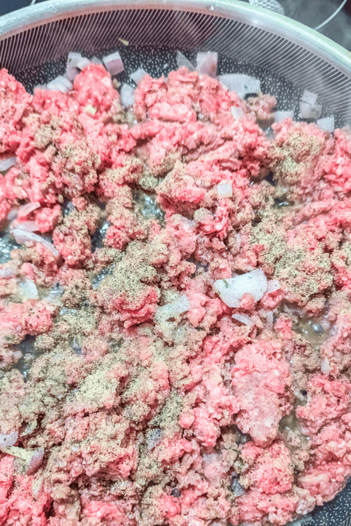 adding salt and pepper to browning meat