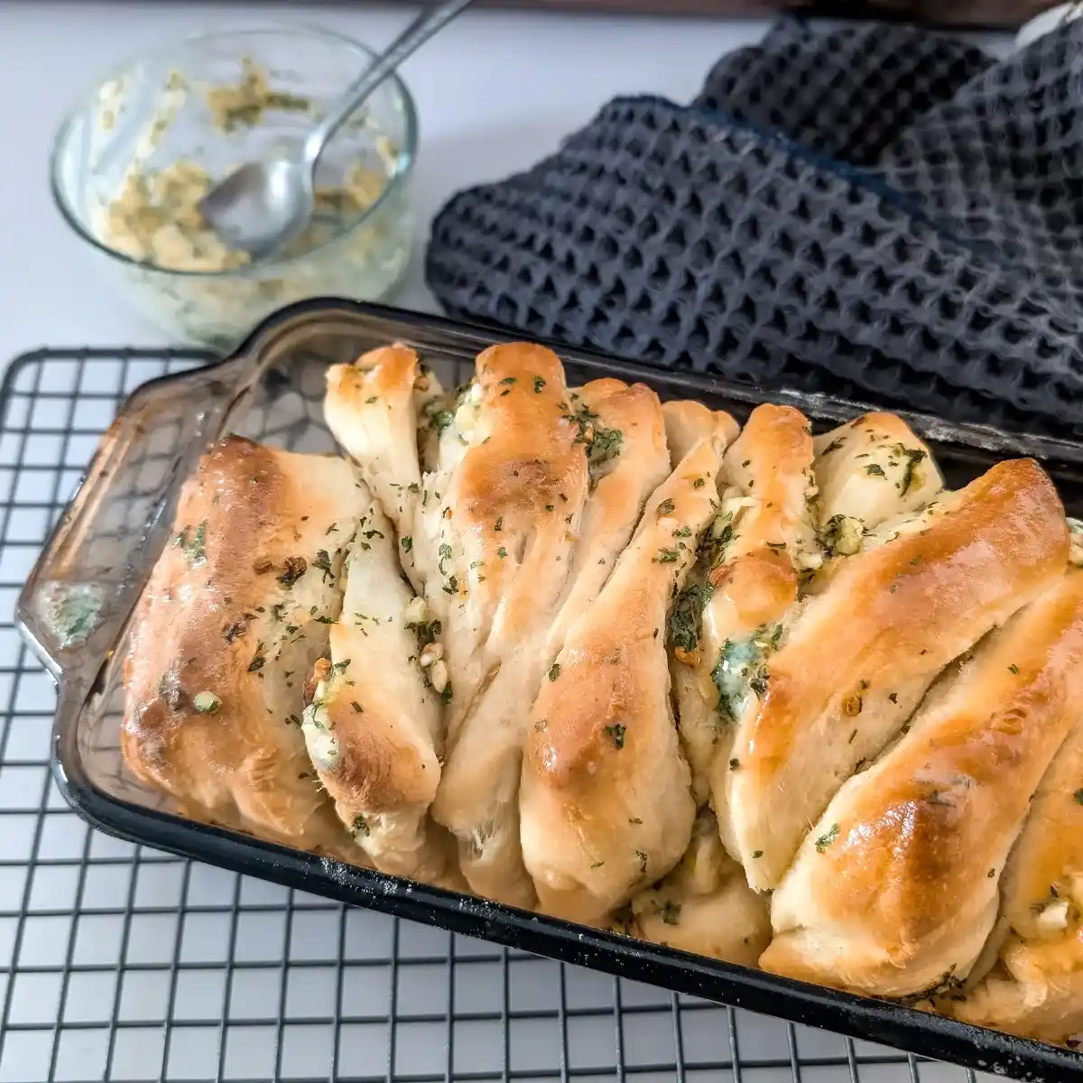 pizza dough garlic bread in loaf pan on wire rack