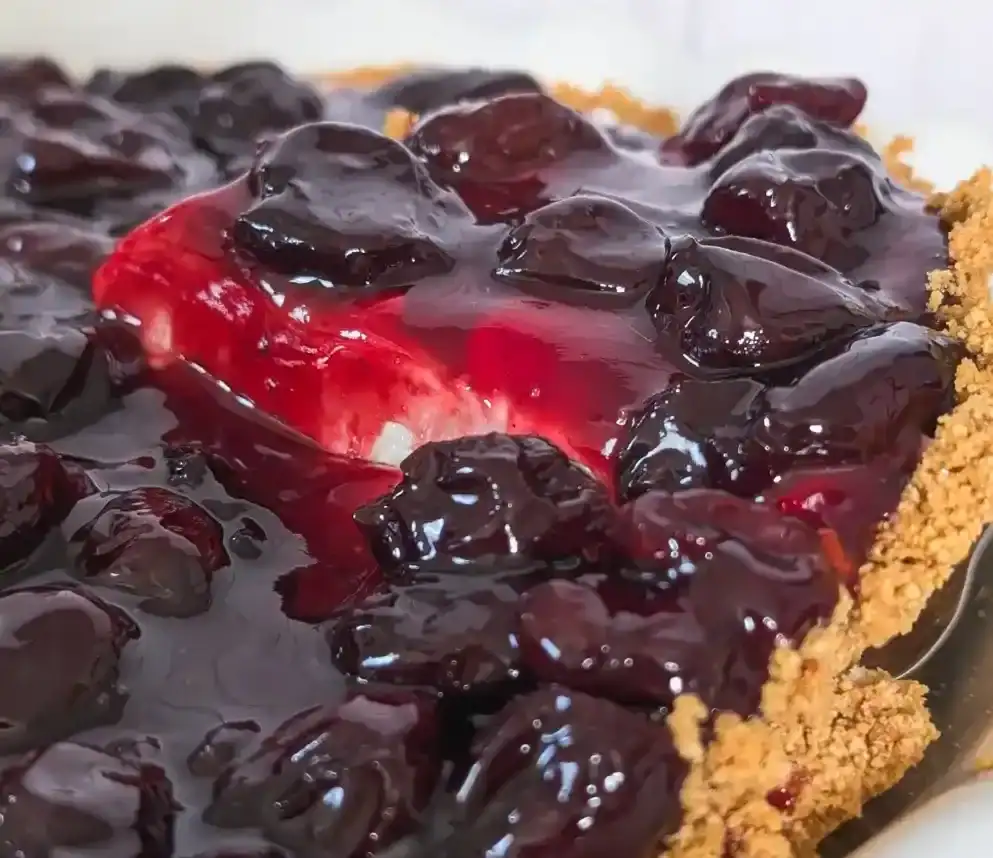 slicing into the cheesecake pie