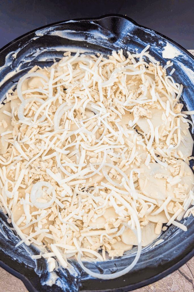 adding a cheese layer to potato dish