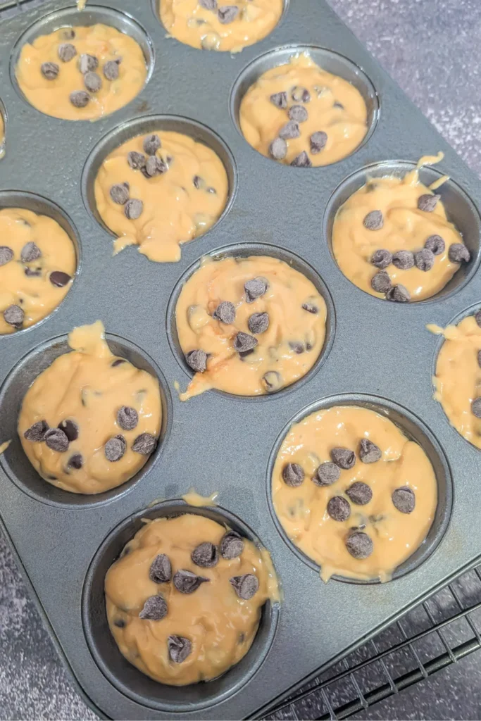 adding extra chocolate chip to top of the muffin