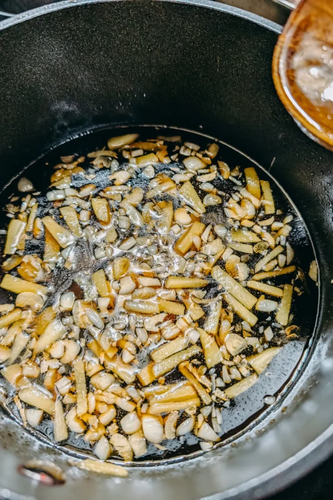 adding honey to aromatics in saucepan