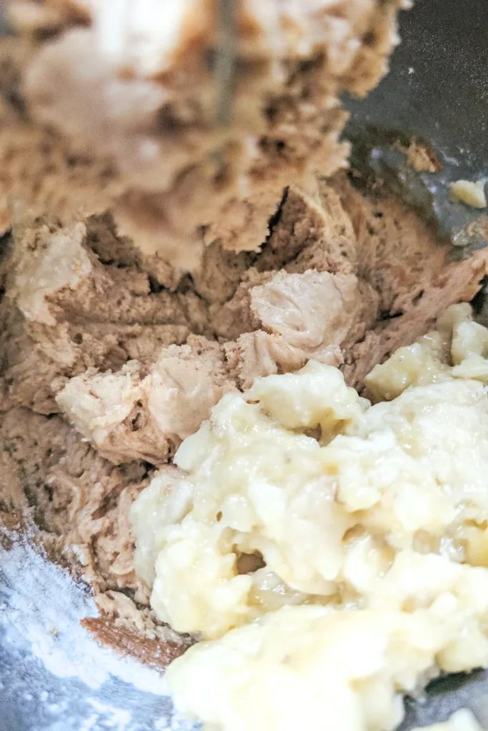 adding the mashed bananas to muffin mixture
