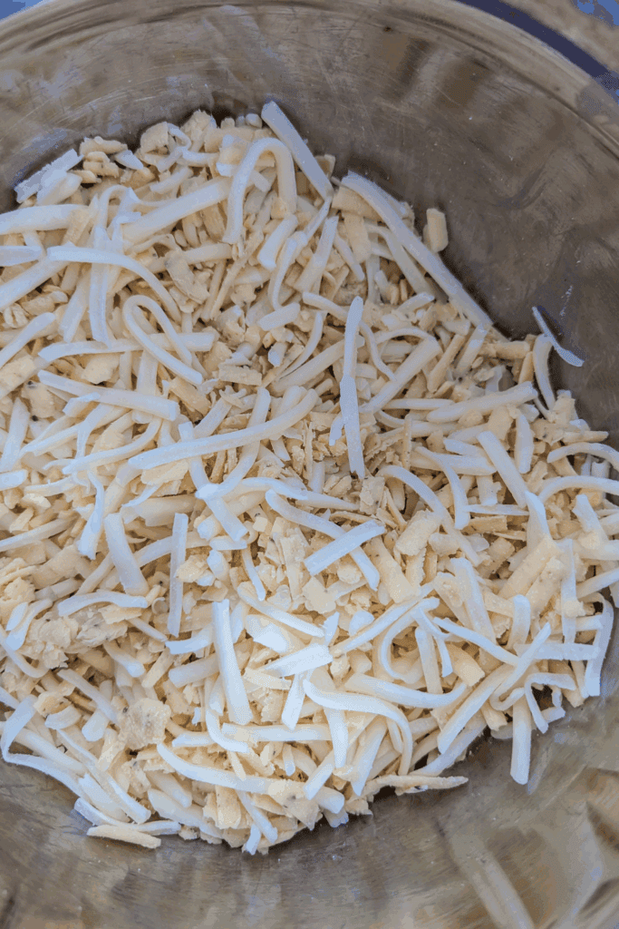 making a cheese blend of black truffle cheese and mozzarella