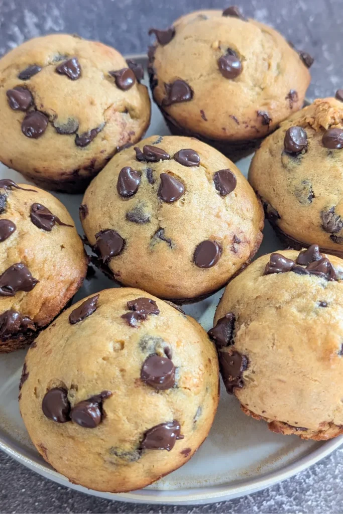 muffins on a plate with chocolate chip tops