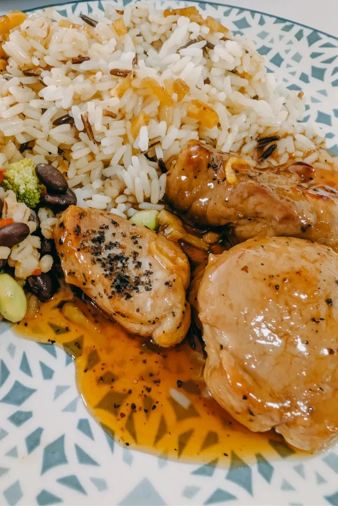 sauced tenderloin medallions on plate with wild rice and frozen bean veg mix