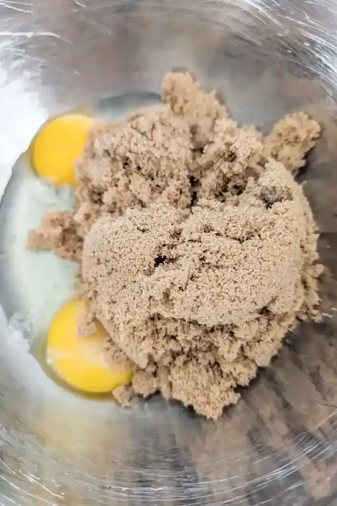 add brown sugar to eggs_ in stainless steel mixing bowl