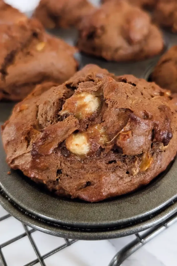 hunks of banana and walnut pieces in chocolate banana muffins