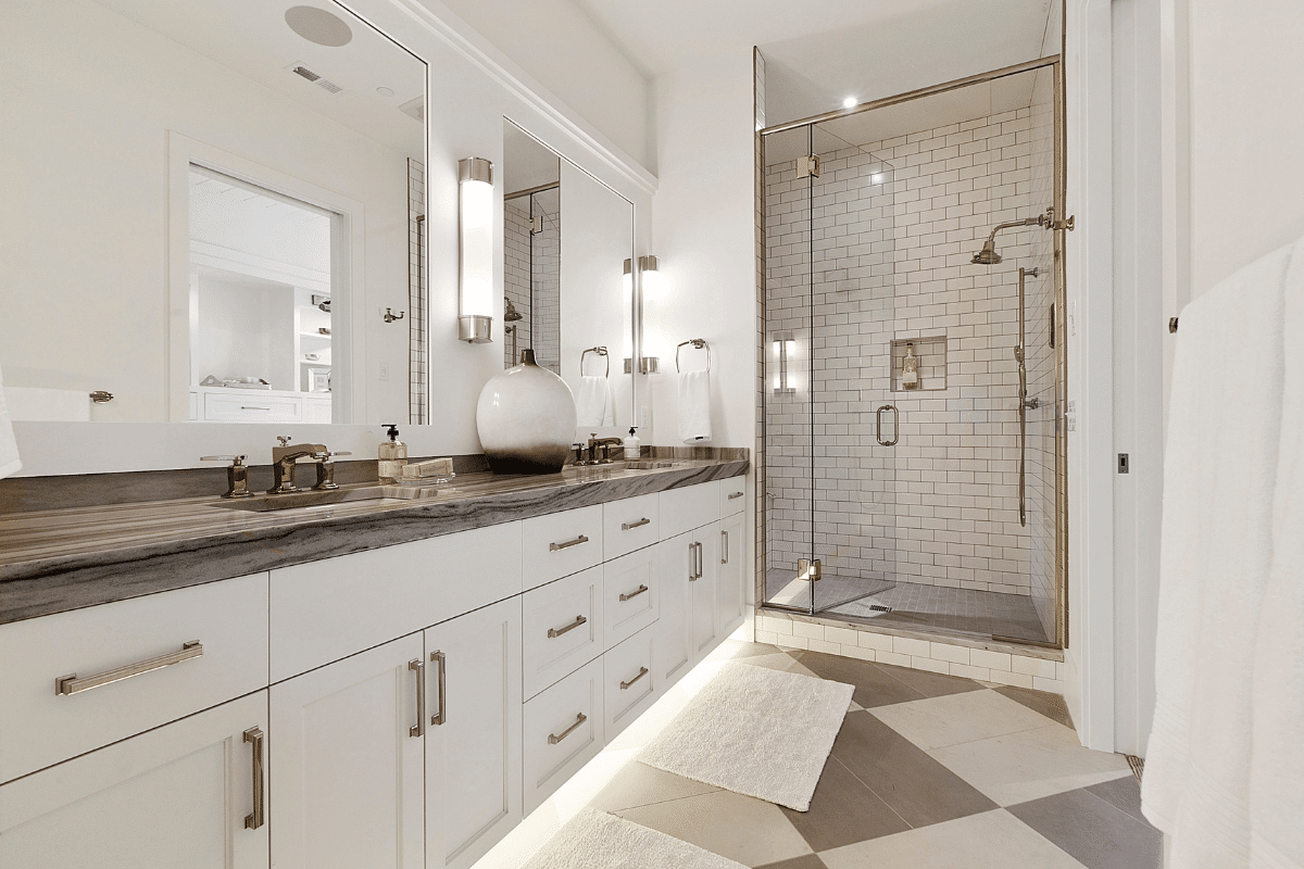 A clean, modern bathroom with double sinks and a bright, open feel. Great example of Chupps Interior Construction work.