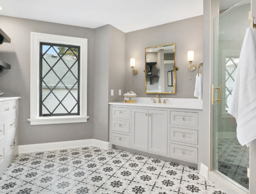 Chupps Interior Construction shows a stylish bathroom remodel with bold floors, sleek walls, and elegant details.