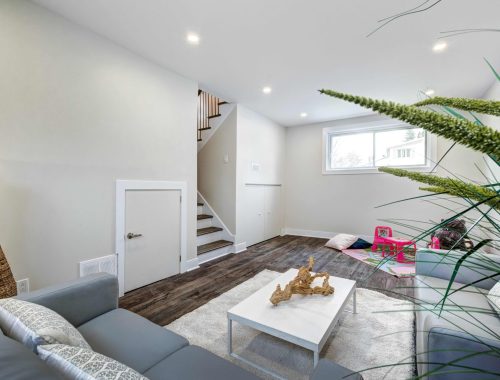 A cozy living room designed by Chupps Interior Construction shows a welcoming space for families, with relaxing areas and room to play.