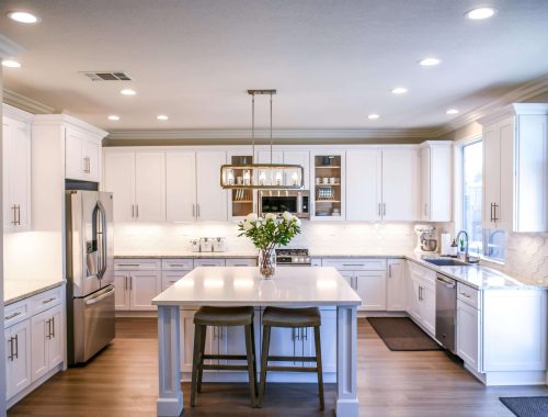 A bright and welcoming kitchen by Chupps Interior Construction with plenty of space to cook, eat, and spend time together.