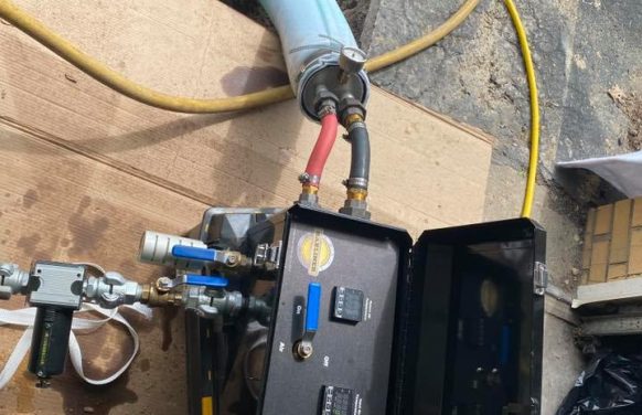 The photo shows Cirigliano Plumbing LLC working on a pipe underground, showing their skill in plumbing repairs.