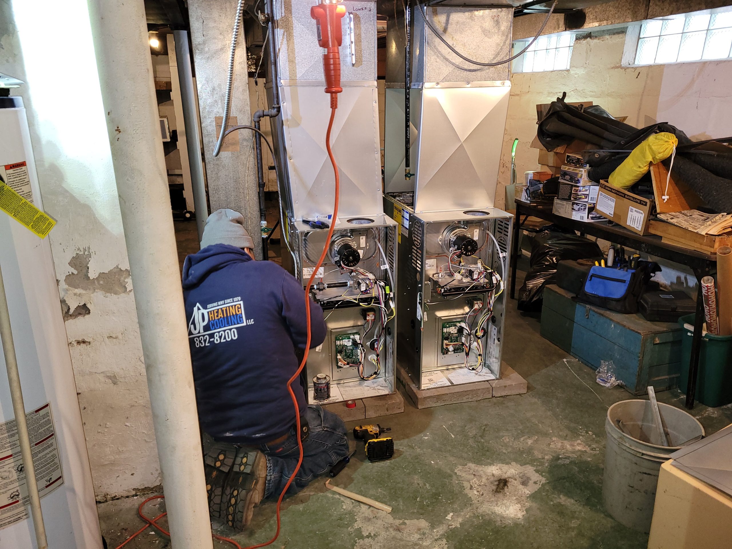 A JP Heating & Cooling technician is fixing and replacing two furnaces to help keep a home warm and safe.
