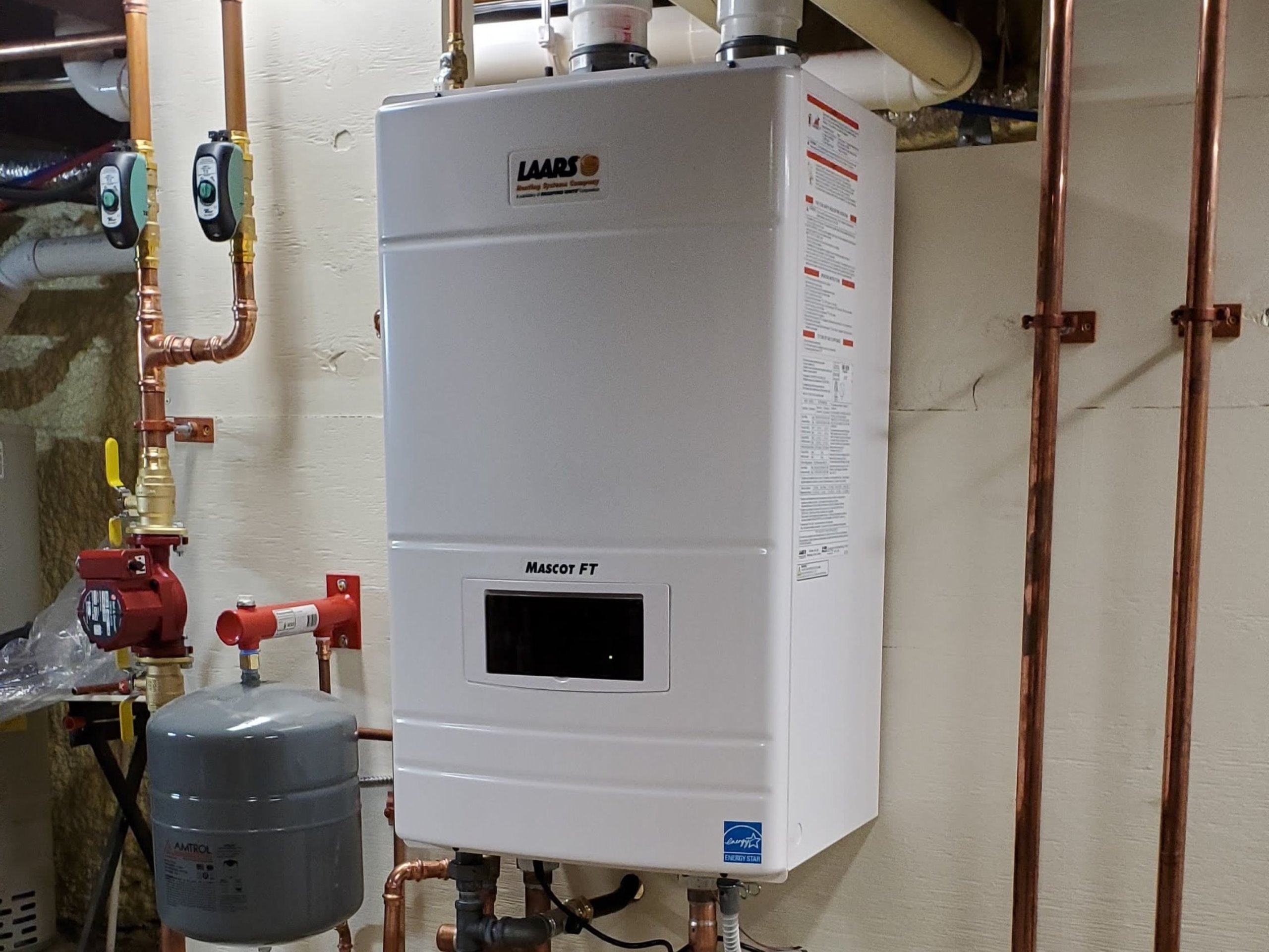 A neatly installed white boiler shows JP Heating & Cooling’s skill in providing reliable and professional heating services.