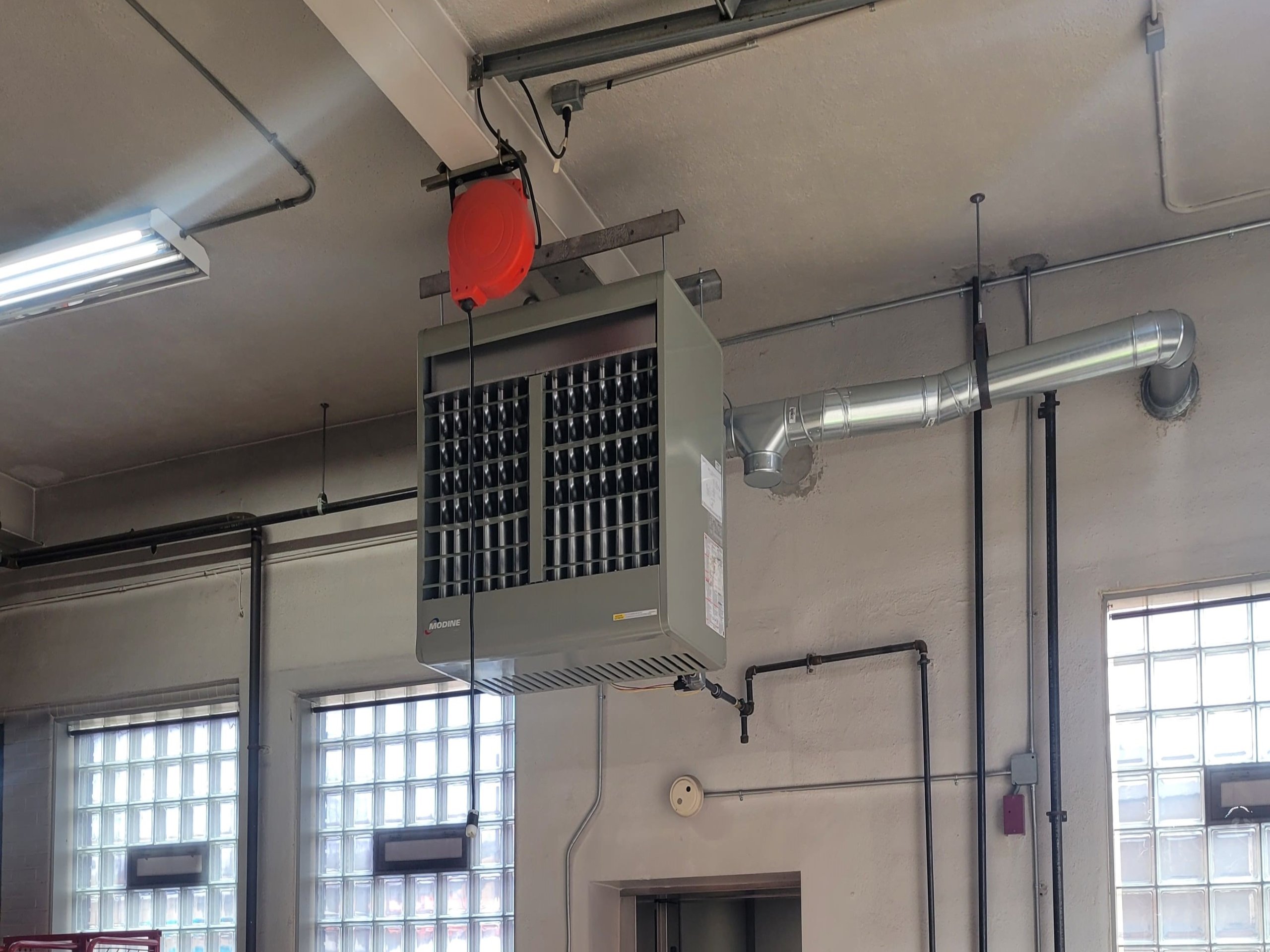 Ceiling-mounted industrial heater shows how JP Heating & Cooling can help with furnace repair and replacement in big spaces.