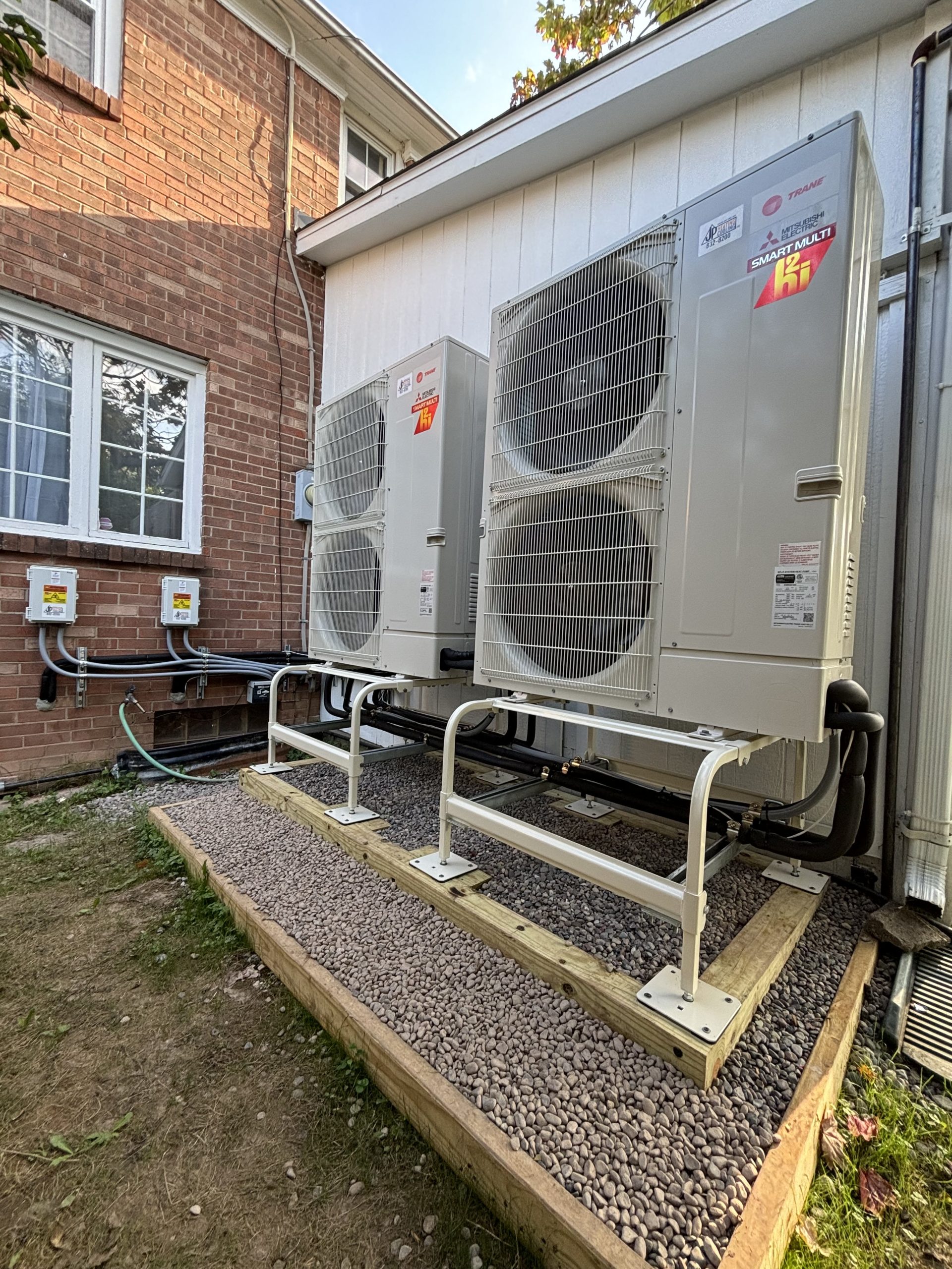Two large AC units on stands show JP Heating & Cooling can handle air conditioning and boiler service for businesses.