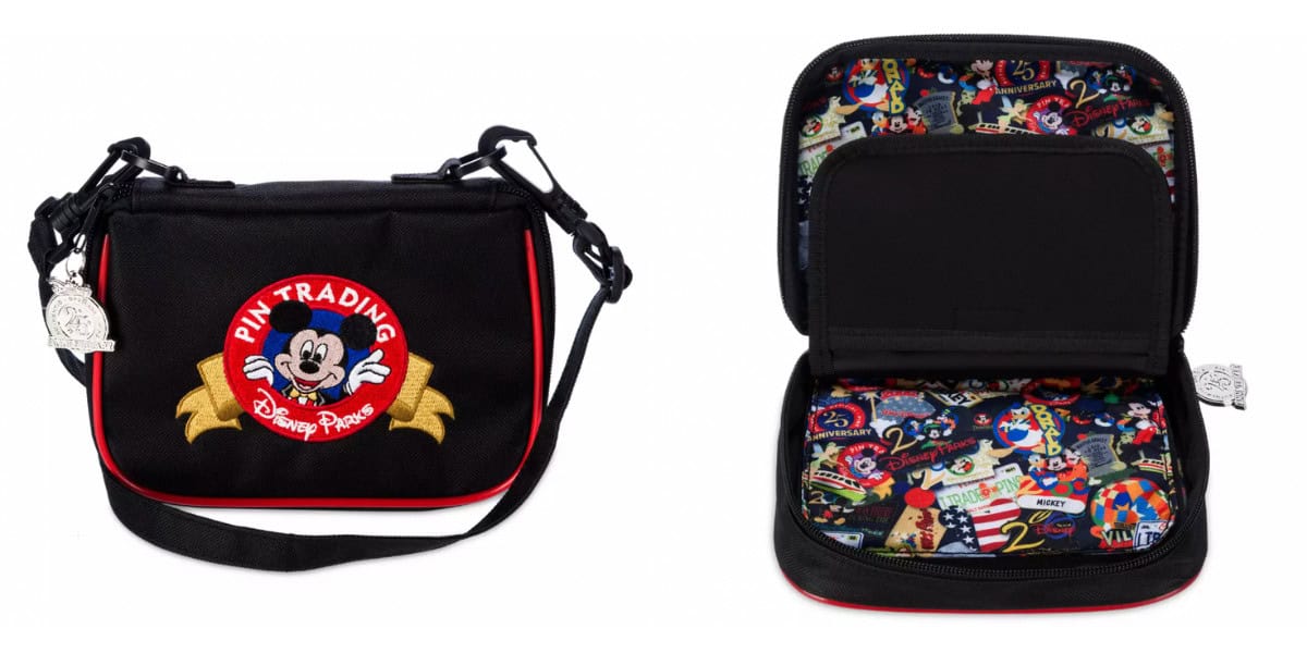 Black pin trading bag with a handle, featuring a Mickey Mouse logo on the front. The interior is open, displaying a colorful, Disney-themed print with various characters and park icons. A silver charm is attached to the zipper.