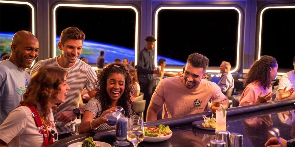 A group of smiling people gathered around space220 lounge