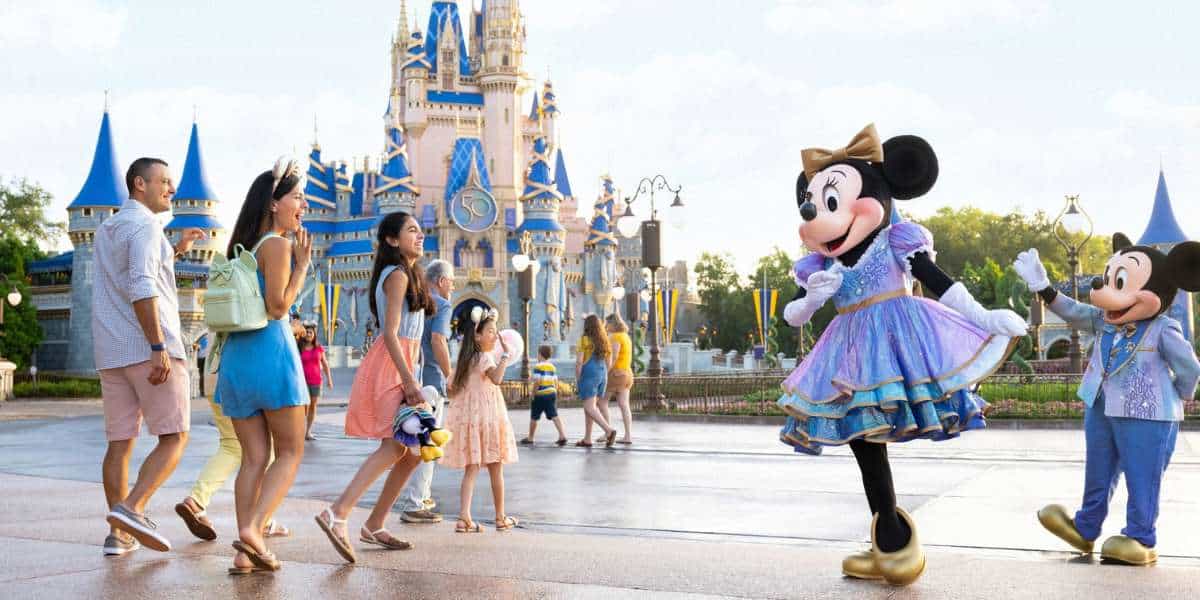 Guests with Mickey and Minnie in front of Cinderella Castle
