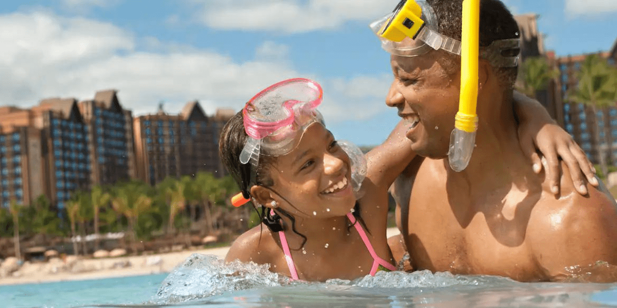 Swimming Father and Daughter at Aulani Coast
