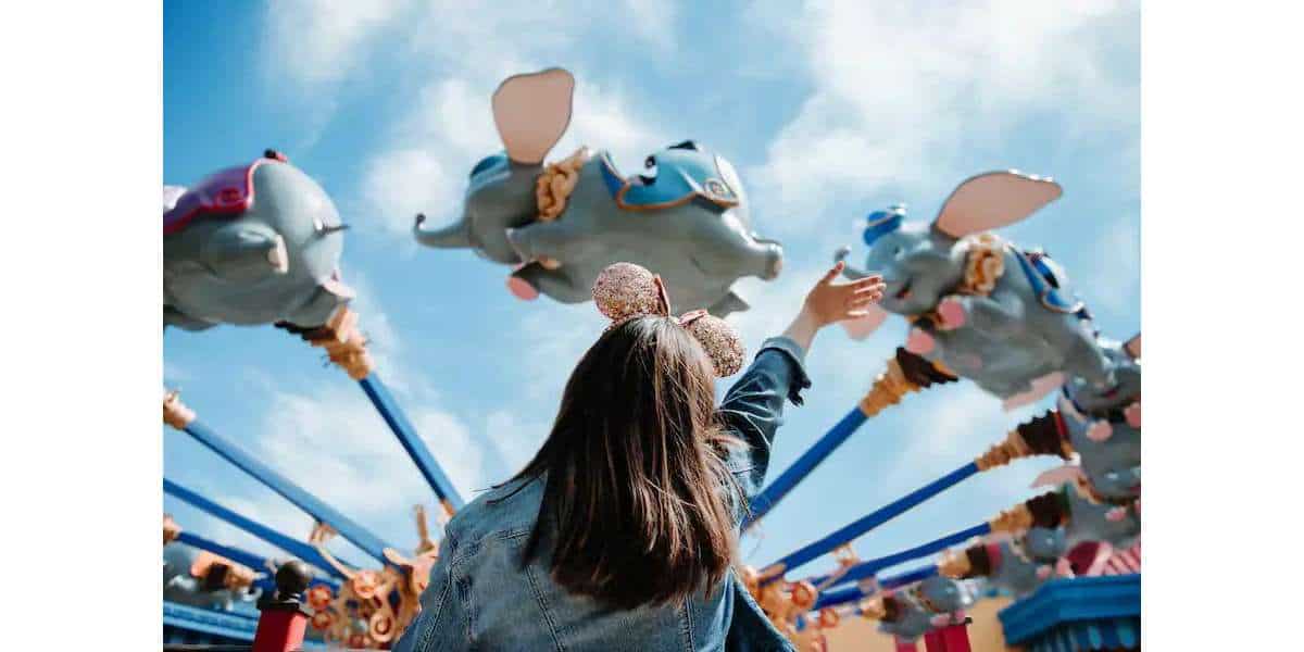 Guest outside of Dumbo the Flying Elephant in the Magic Kingdom
