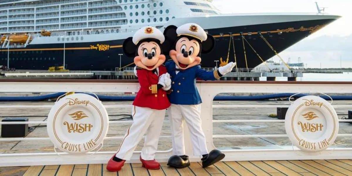 Mickey and Minnie in front of a Disney Cruise Line ship