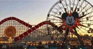Mickey's Fun Wheel and Incredicoaster at dusk.