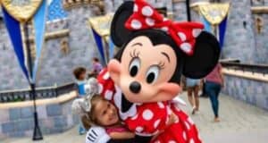 Minnie Mouse hugging a Disney Guest