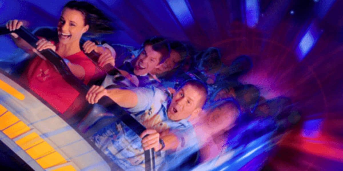 A man and a woman in a Disneyland ride vehicle - Space Mountain.