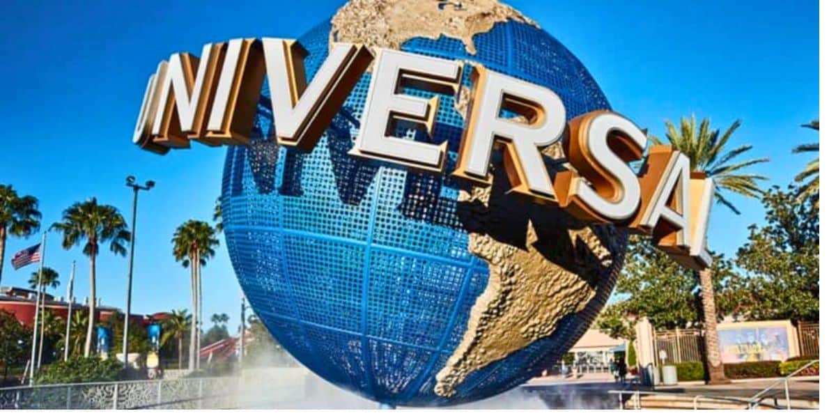 Rotating globe with the Universal Studios logo, under a clear blue sky, welcoming visitors to an adventurous theme park experience.