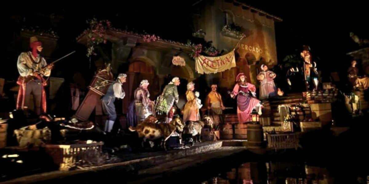 Auction scene featuring Pirate Redd, the auctioneer, and townspeople in the Pirates of the Caribbean attraction at Magic Kingdom in Walt Disney World Resort