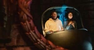 A man and woman ride in a Doom Buggy on the Haunted Mansion at Disneyland
