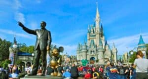 Guests look on inside the Magic Kingdom besides the Walt Disney and Mickey Mouse statue, Partners, at Walt Disney World Resort