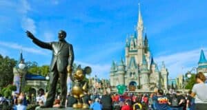 Guests look on inside the Magic Kingdom besides the Walt Disney and Mickey Mouse statue, Partners, at Walt Disney World Resort