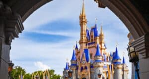 Cinderella Castle in Magic Kingdom at Walt Disney World Resort as seen from an archway.