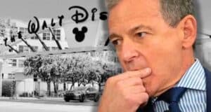 Disney CEO Bob Iger looking worried in front of the Walt Disney Company building.