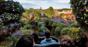 A group of people approaching the highest Tiana's Bayou Adventure drop.