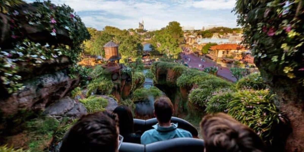 A group of people approaching the highest Tiana's Bayou Adventure drop.