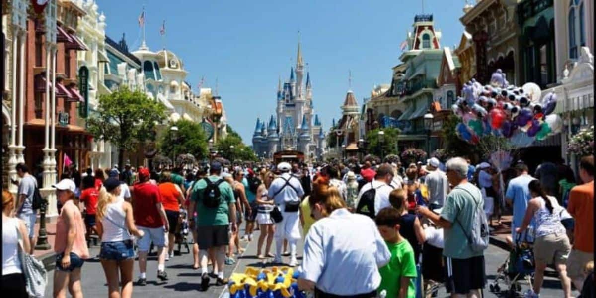 Crowds on Main Street, U.S.A., at Walt Disney World Resort on a sunny day. 