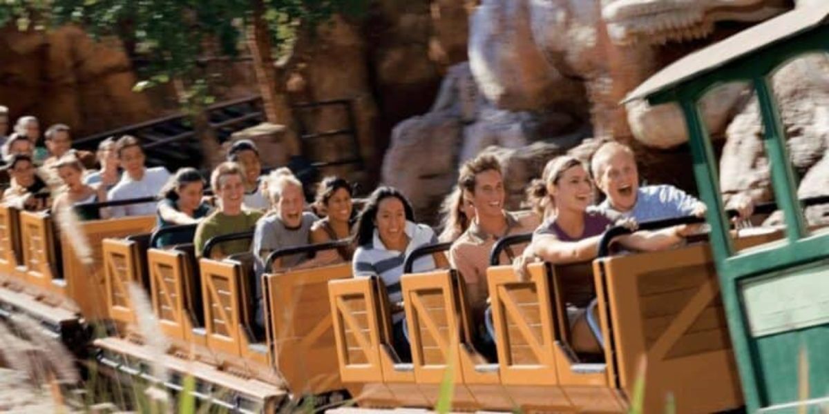 A group of people riding Big Thunder Mountain Railroad at Magic Kingdom. 