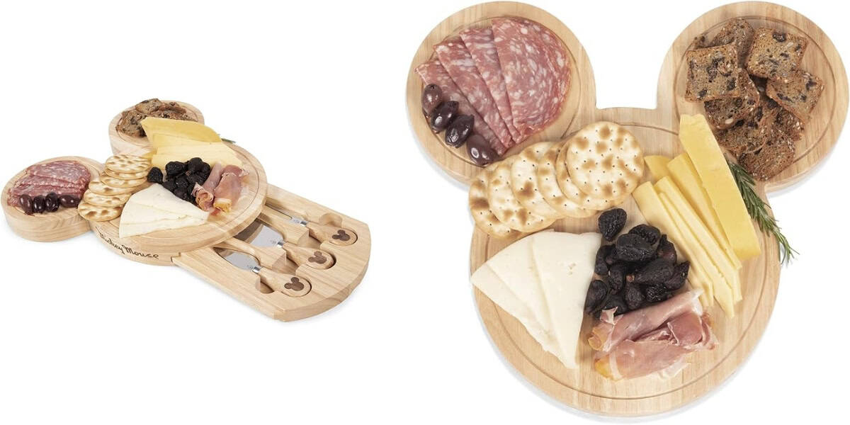 Two images of a Mickey Mouse-shaped wooden cheese board set. The left image shows the board with hidden slide-out trays containing cheese knives. The right image shows the board filled with cheese, crackers, salami, olives, dried fruits, and rosemary sprigs.