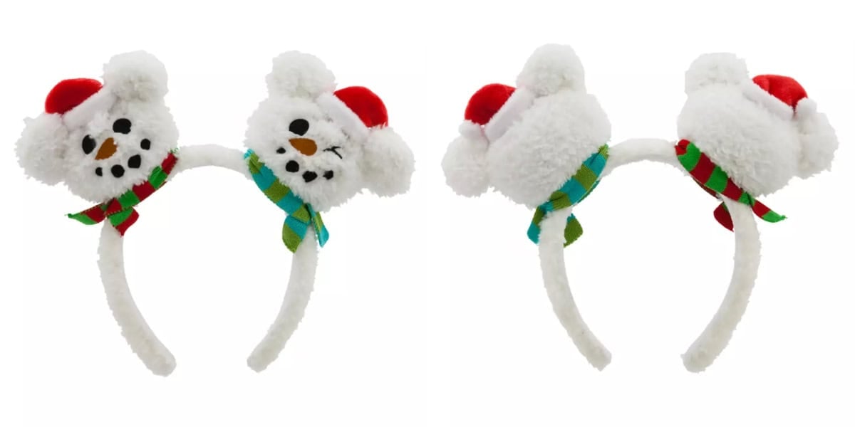 A pair of white plush headbands featuring cute snowman faces with black eyes and a carrot-shaped nose. Each snowman wears a red Santa hat and a green and blue striped scarf. Image shows both the front and back views of the headbands.