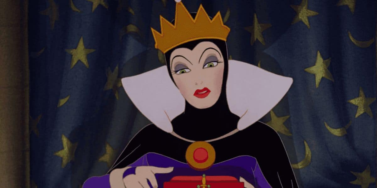 An illustrated queen, reminiscent of Disney's scariest villains, in a dark outfit and gold crown gazes down at a small red box in her hands. The backdrop is a curtain adorned with stars.